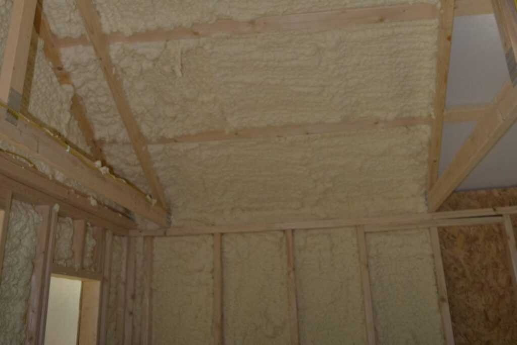 the inside walls and ceiling of a shed with spray foam insulation