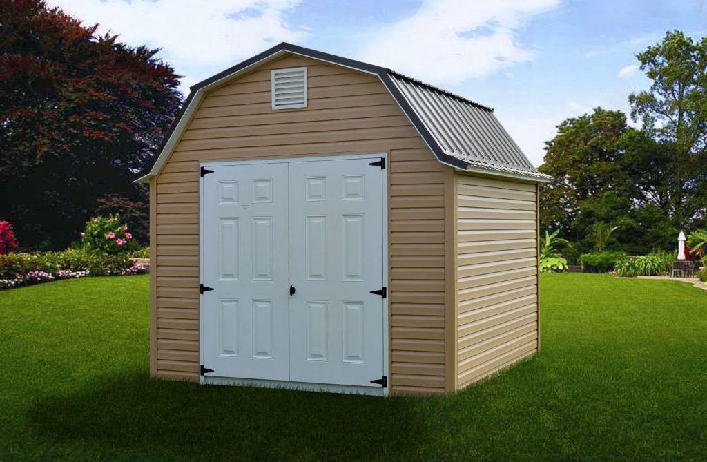 Lofted Gambrel Barn shed with tan siding, white double doors, a white vent, and dark gray metal roofing.