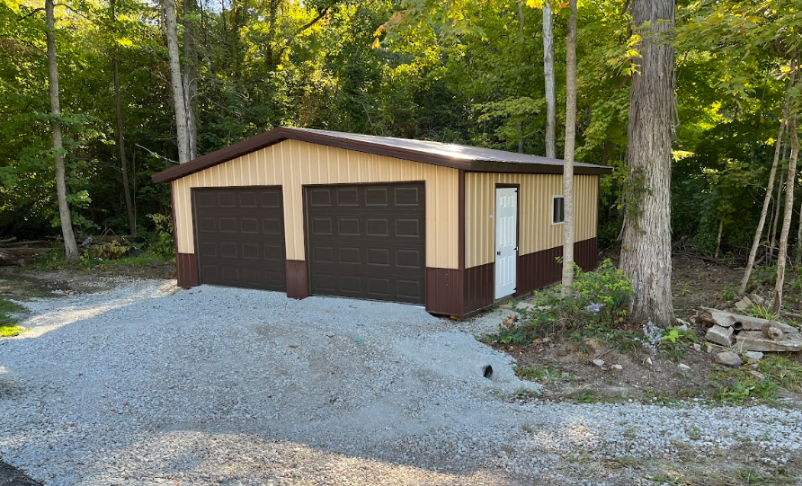 2 car garage with brown garage doors, a white door and window on the side, tan siding, brown foundation, and brown roof