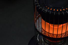 black combustion kerosene heater with orange heat light 